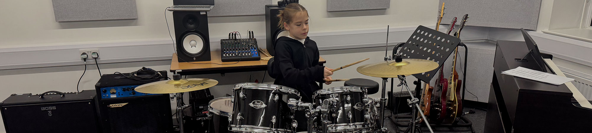 Girl playing drumkit at Wrexham Sounds