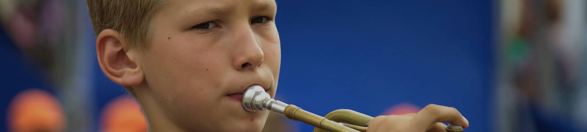 Young boy playing trumpet in Wrexham