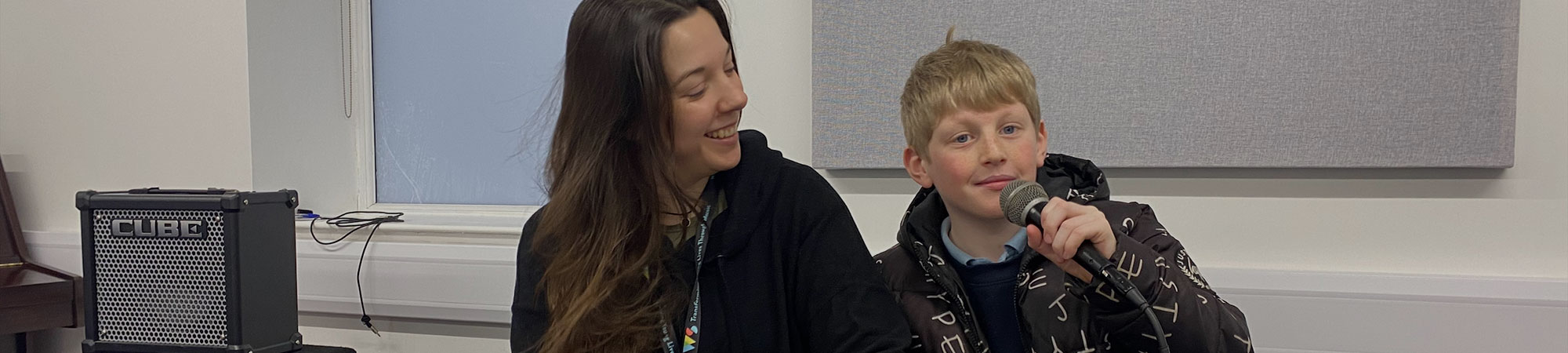 Young boy with piano teacher in Wrexham