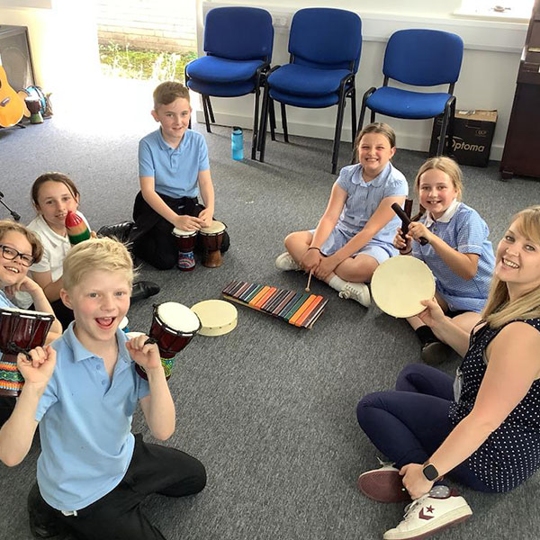 Group of children with music teacher