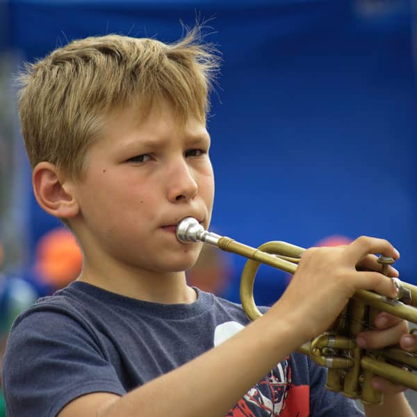 Young boy playing trumpet in Wrexham