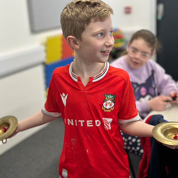 Young boy at music workshop in Wrexham